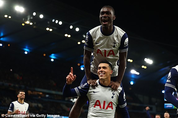 MANCHESTER, ENGLAND - NOVEMBER 23: Pedro Porro of Tottenham Hotspur celebrates  with Yves Bissouma after he scored for 0-3 during the Premier League match between Manchester City FC and Tottenham Hotspur FC at Etihad Stadium on November 23, 2024 in Manchester, England. (Photo by Shaun Brooks - CameraSport via Getty Images)