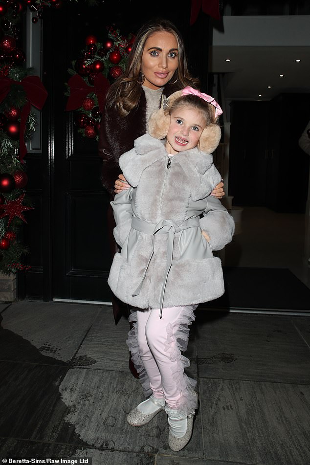 Polly looked adorable in frilled trousers and a grey fur coat