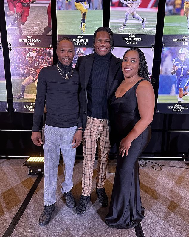 Colorado star Hunter (center) poses previously with his dad Travis Sr (left) and mom (right)