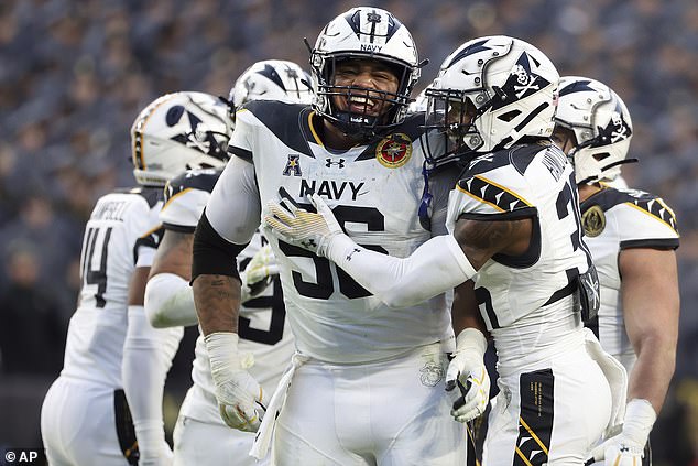 Navy defensive tackle Landon Robinson (96) celebrates with cornerback Phillip Hamilton (36)