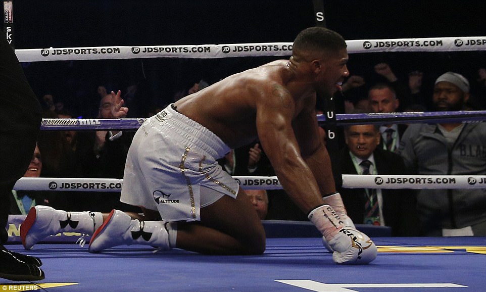 Joshua sticks his tongue out in the direction of the corner after being dropped by a superb shot from Klitschko