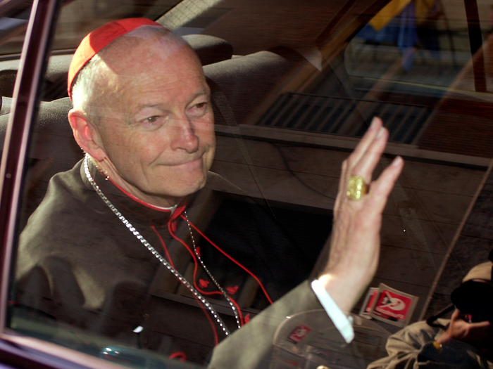 FILE - In this April 23, 2002 file photo Cardinal Theodore McCarrick of the Archdiocese of Washington, waves as he arrives at the Vatican in a limousine. On Saturday, Feb. 16, 2019 the Vatican announced Pope Francis defrocked former U.S. Cardinal Theodore McCarrick after Vatican officials found him guilty of soliciting for sex while hearing Confession.  (AP Photo/Andrew Medichini, file)