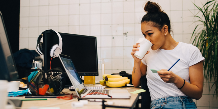 woman working drinking coffee laptop