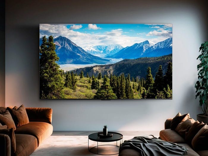 A TCL Q7 4K QLED TV hanging on a wall in a living room