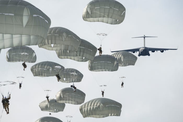 Army paratroopers from the 4th Infantry Brigade Combat Team (Airborne), 25th Infantry Division, U.S. Army Alaska, descend after jumping from a U.S. Air Force C-17 Globemaster III over Malemute Drop Zone during airborne training at Joint Base Elmendorf-Richardson, Alaska, March 24, 2022.