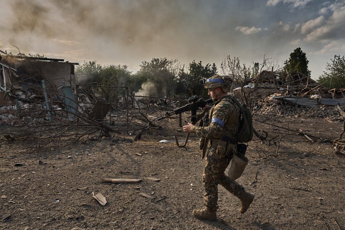 Ukrainian soldiers passing through the border city of Vovchansk, in Chuhuiv Raion, Kharkiv Oblast