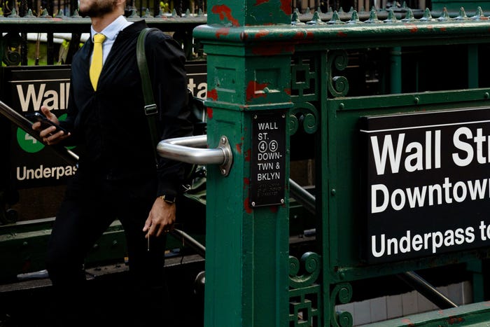 Man in a suit exits the Wall Street subway station