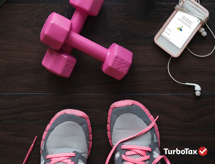 there is a pair of pink shoes next to a cell phone and dumbbells