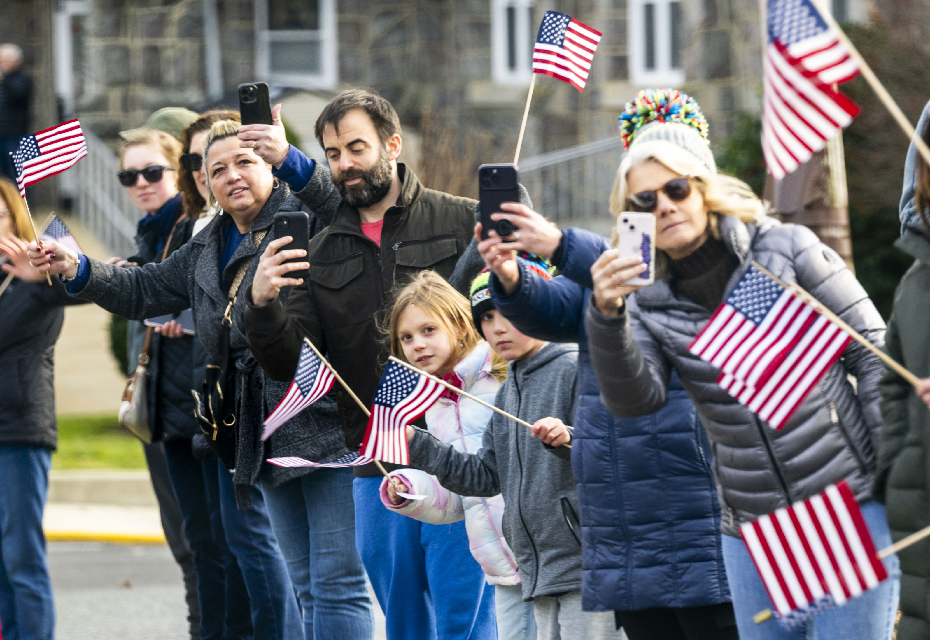 People line the streets Friday, Jan. 12, 2024, in Emmaus as President Joe Biden's motorcade prepares to leave the borough. The president visited the Lehigh Valley to meet with small business owners and highlight his economic agenda. (April Gamiz / The Morning Call)