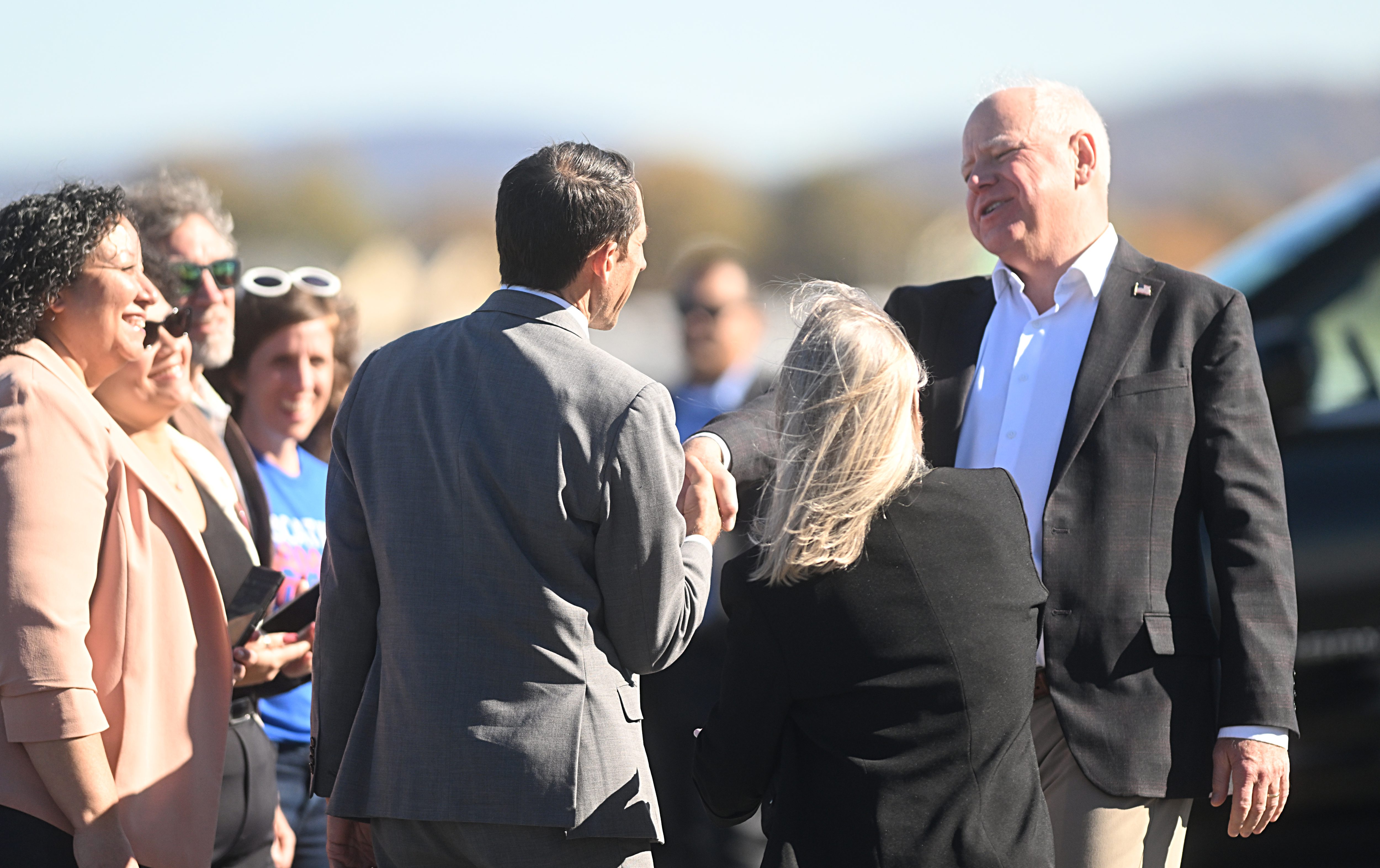 Democratic vice presidential candidate and Minnesota Gov. Tim Walz greets U.S. Rep. Susan Wild, D-7th, and Allentown Mayor Matt Tuerk on Friday, Oct, 25, 2024, at Lehigh Valley International Airport in Hanover Township, Lehigh County. (Amy Shortell / The Morning Call)