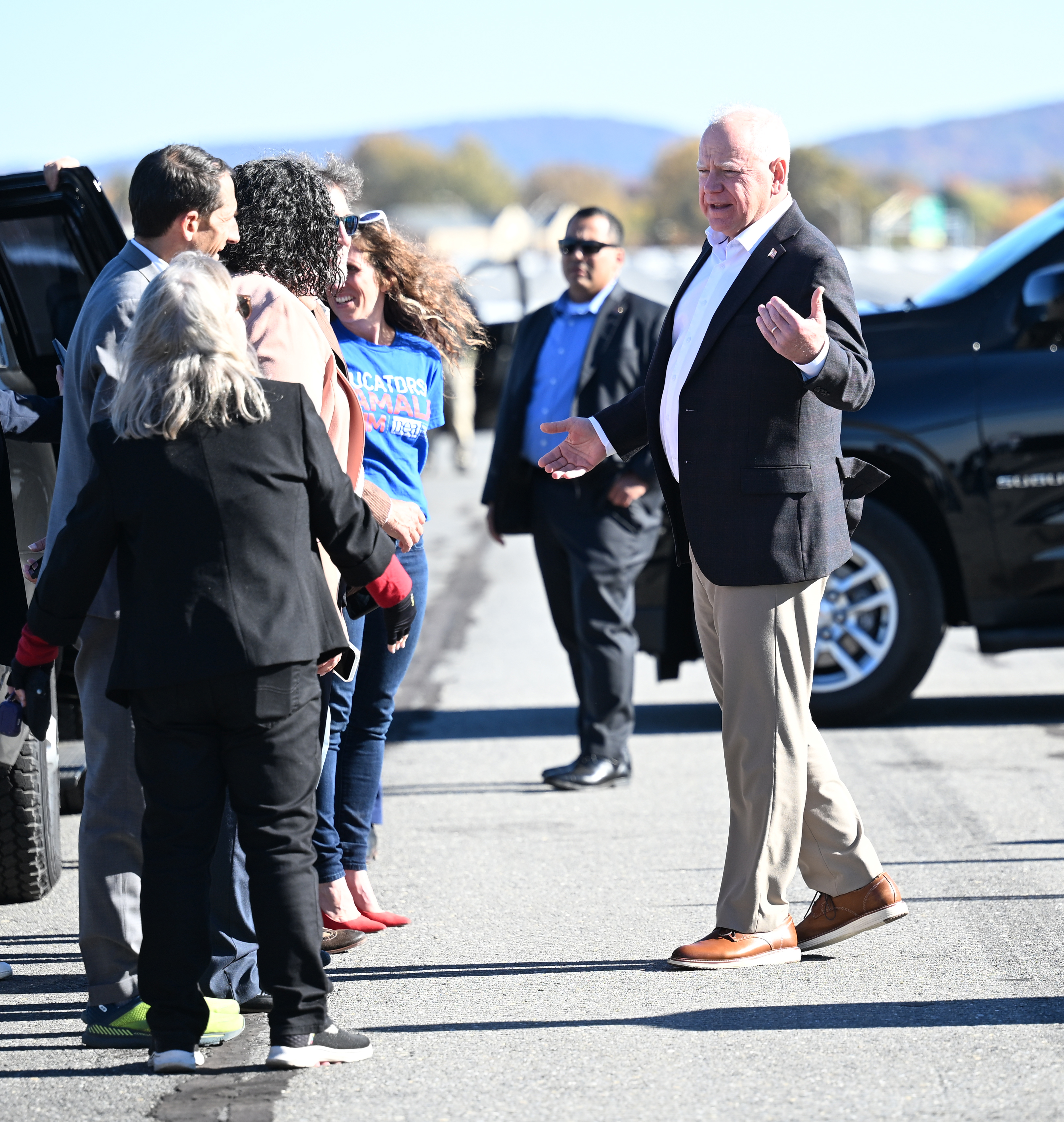 Democratic vice presidential candidate and Minnesota Gov. Tim Walz greets U.S. Rep. Susan Wild, D-7th, and Allentown Mayor Matt Tuerk on Friday, Oct, 25, 2024, at Lehigh Valley International Airport in Hanover Township, Lehigh County. (Amy Shortell / The Morning Call)