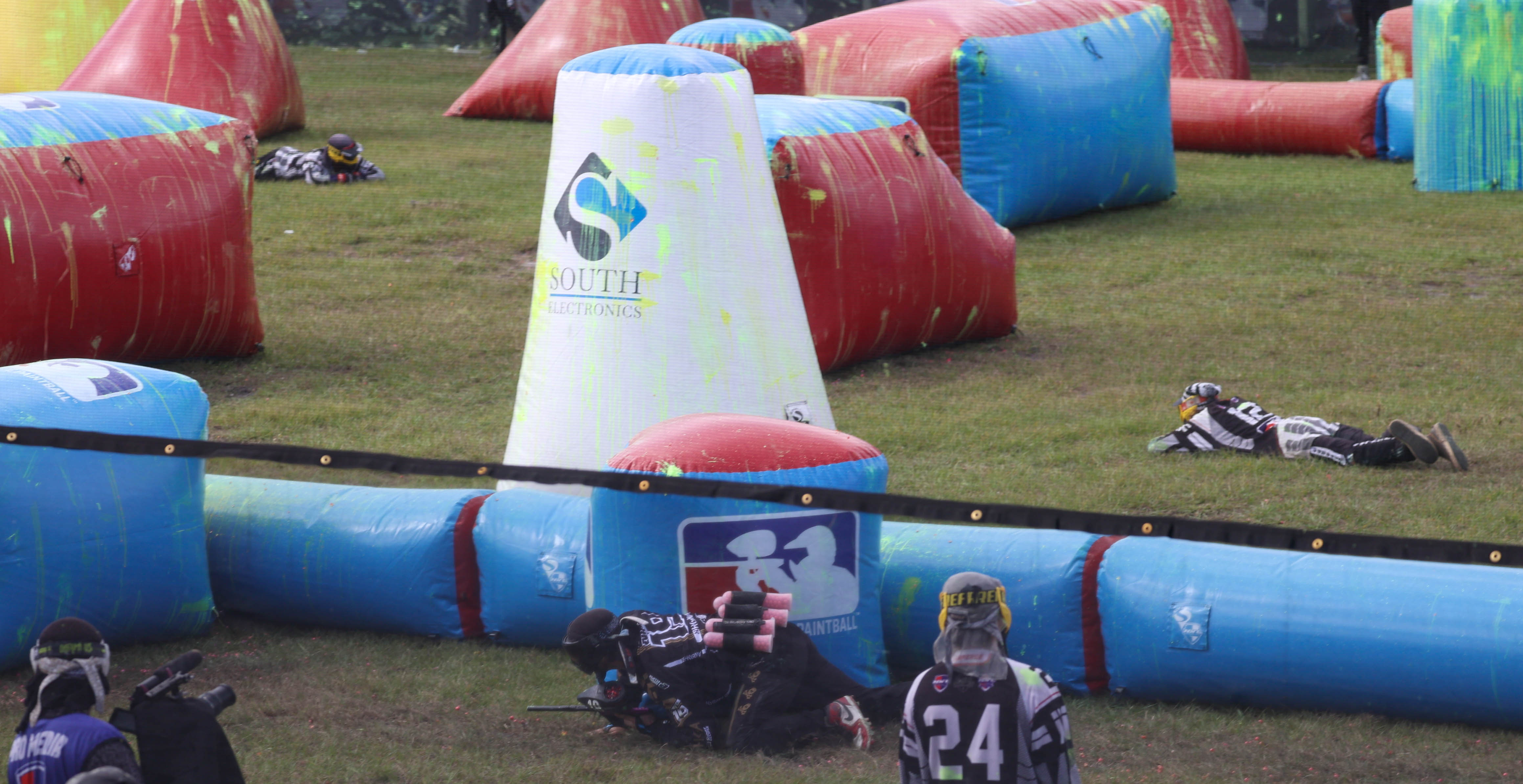 Referees lay low and watch the action on the field to notify players if they have been hit and are out of the round at the NXL World Cup of Paintball tournament in Kissimmee on Thursday, Nov. 7, 2024. (Rich Pope, Orlando Sentinel)