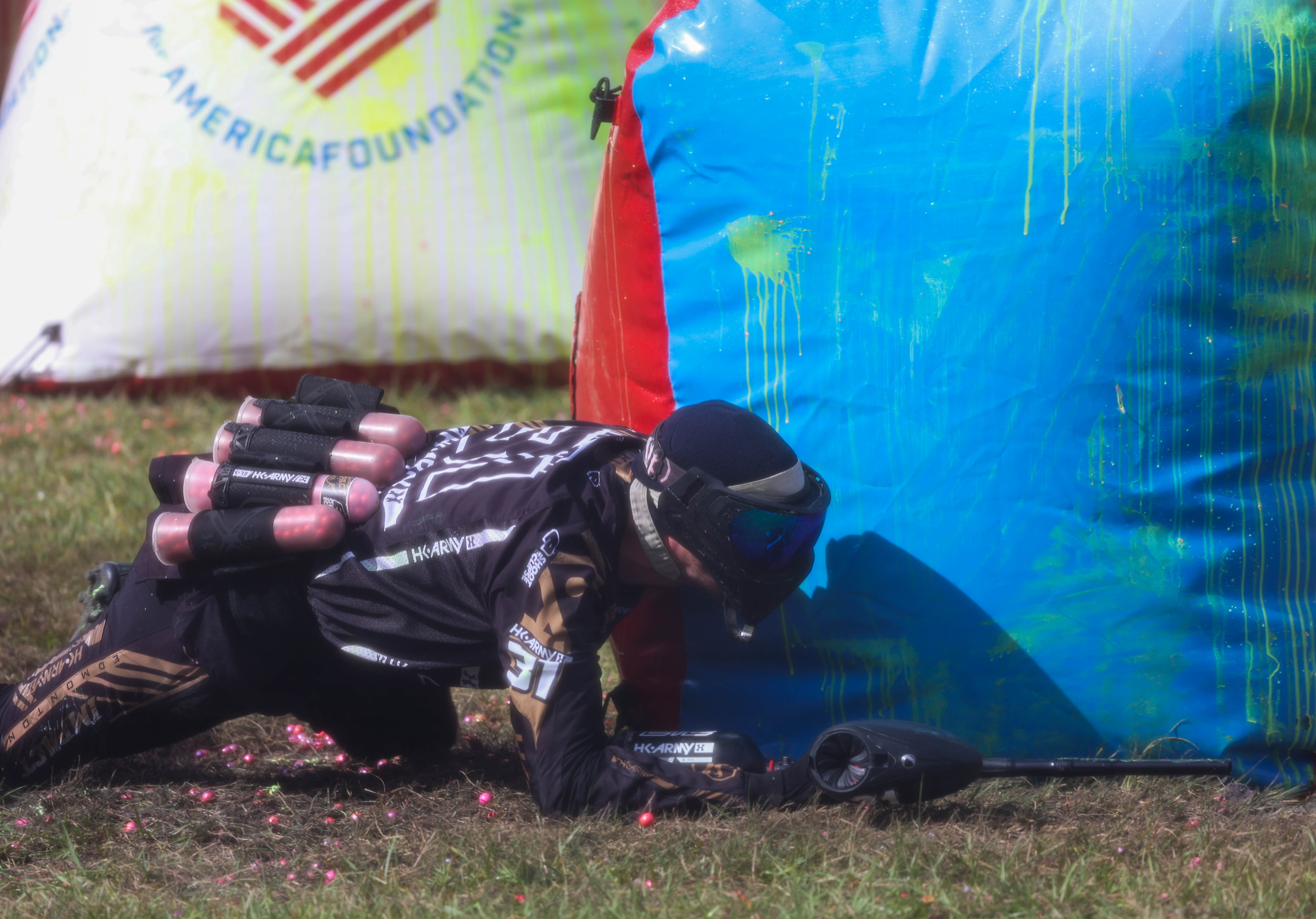 A player from the Edmonton Impact from Canada takes cover and crawls to avoid being hit by a paintball during a pro-level prelim match at the NXL World Cup of Paintball tournament in Kissimmee on Thursday, Nov. 7, 2024. (Rich Pope, Orlando Sentinel)