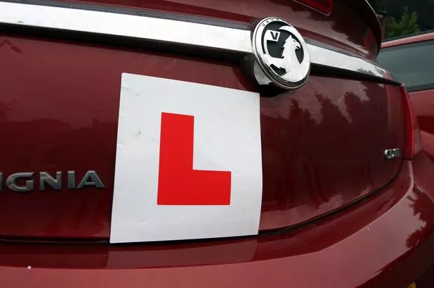 An L plate on the rear of a car