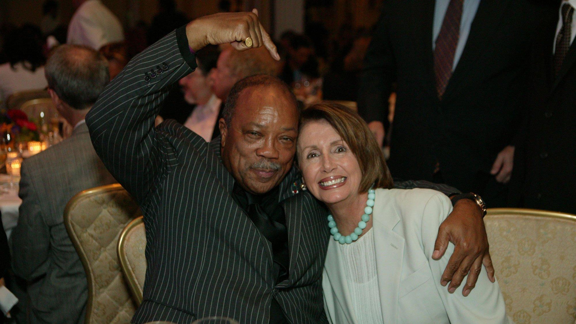 Quincy Jones sits next to then Speaker of the House, Nancy Pelosi.