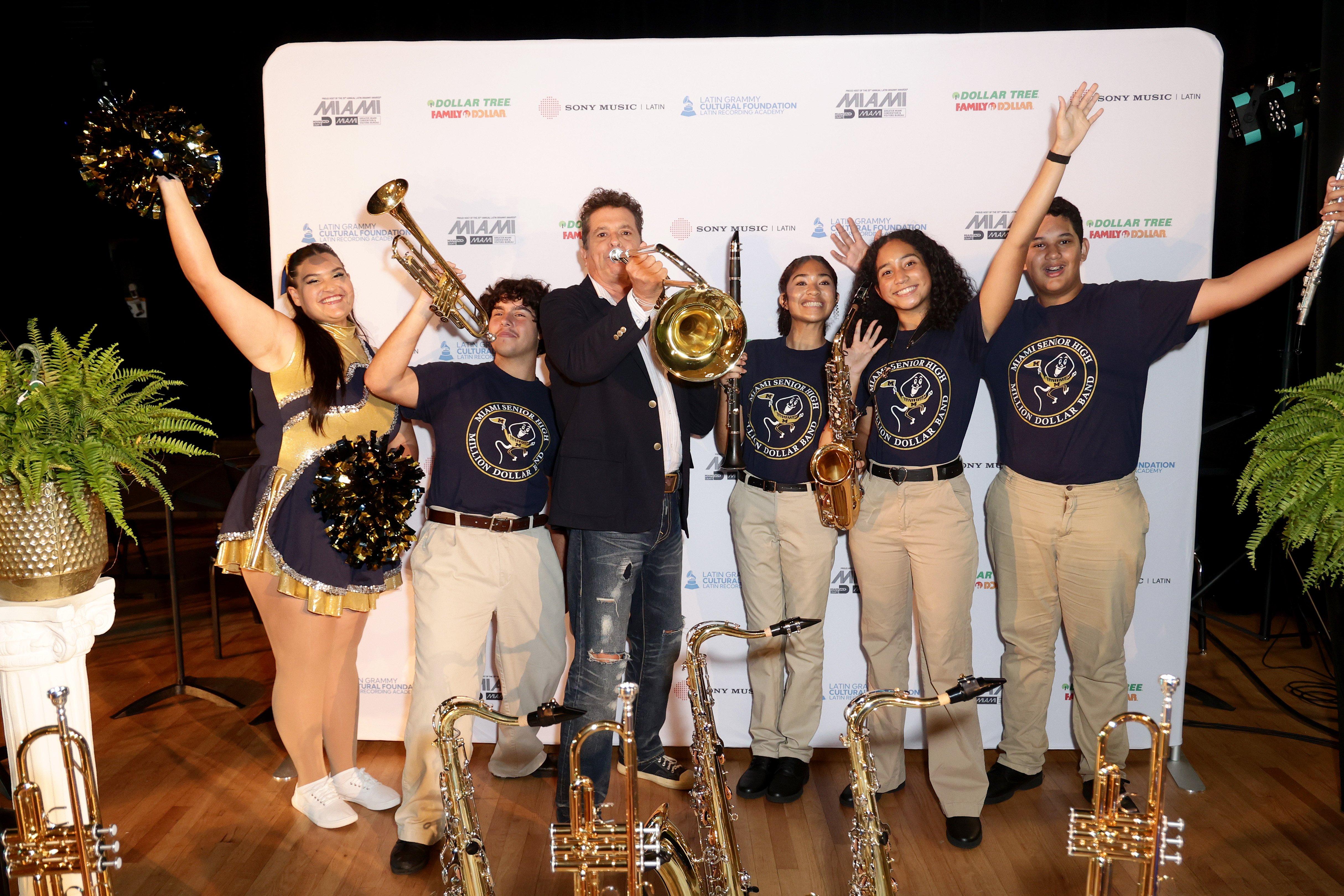 Carlos Vives poses with students of Miami Senior High School during 2024 Latin GRAMMY In The Schools