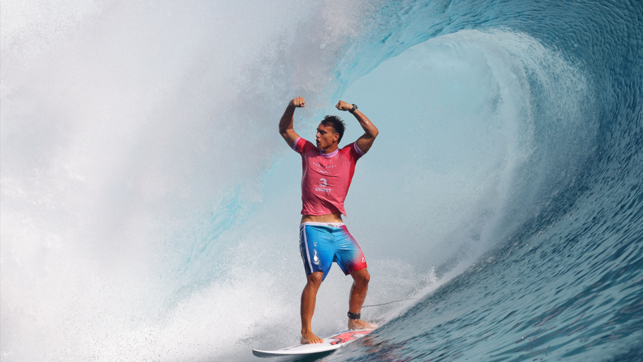 Kauli Vaast celebrates while surfing the Teahupo’o wave after becoming the 2024 Olympic champion