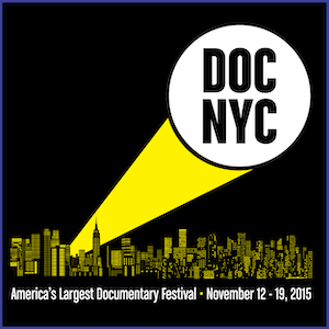 2015 DOC NYC Shirt - Yellow skyline and yellow-white spotlight, with words DOC NYC in the spotlight circle, and text America’s Largest Documentary Festival - November 12-19, 2015. Black Shirt.