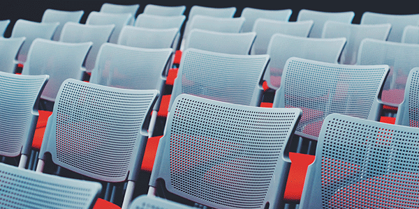 Rows of chairs with red cushions