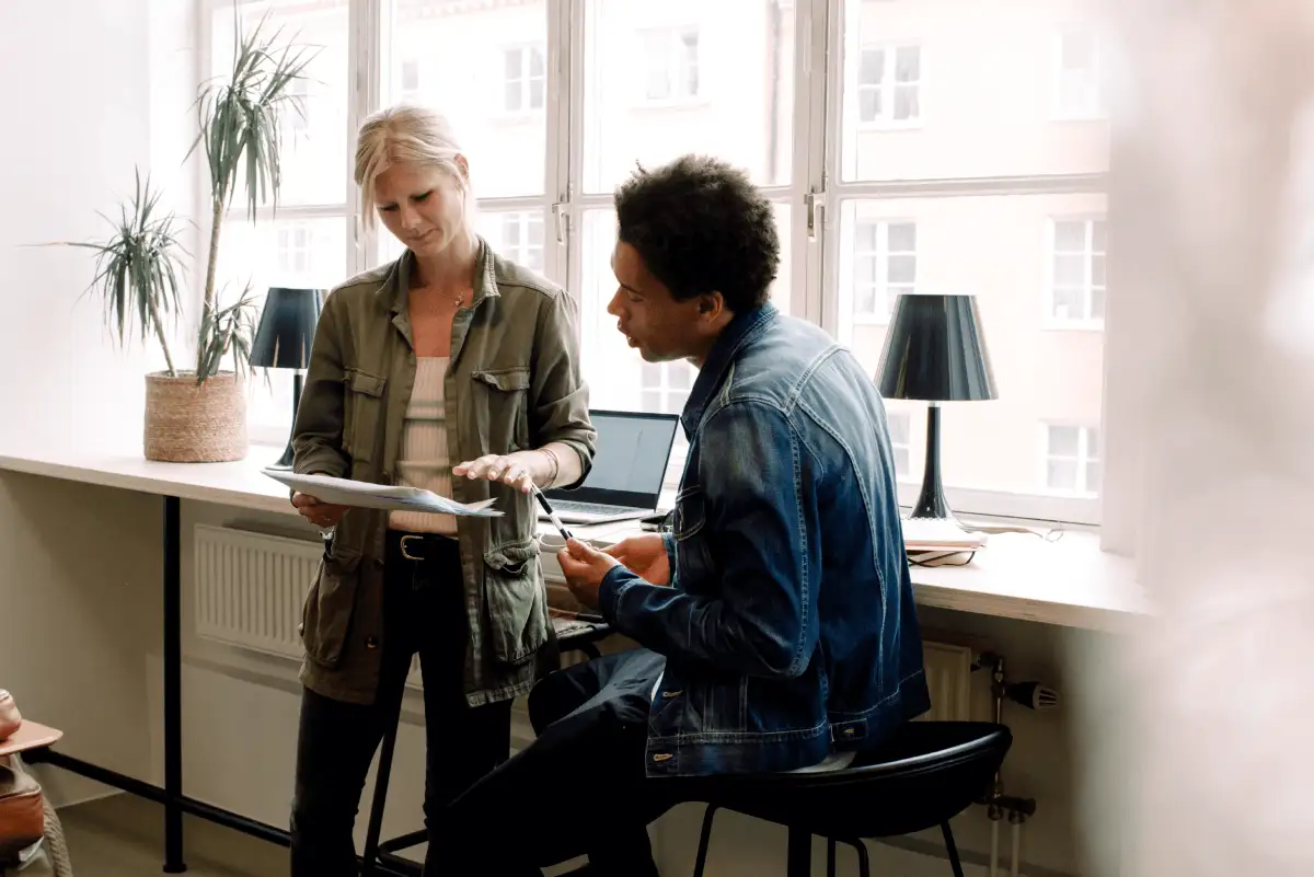 Two employees meet in an airy office