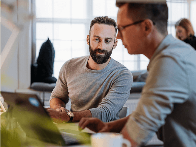 Two people collaborating on a laptop