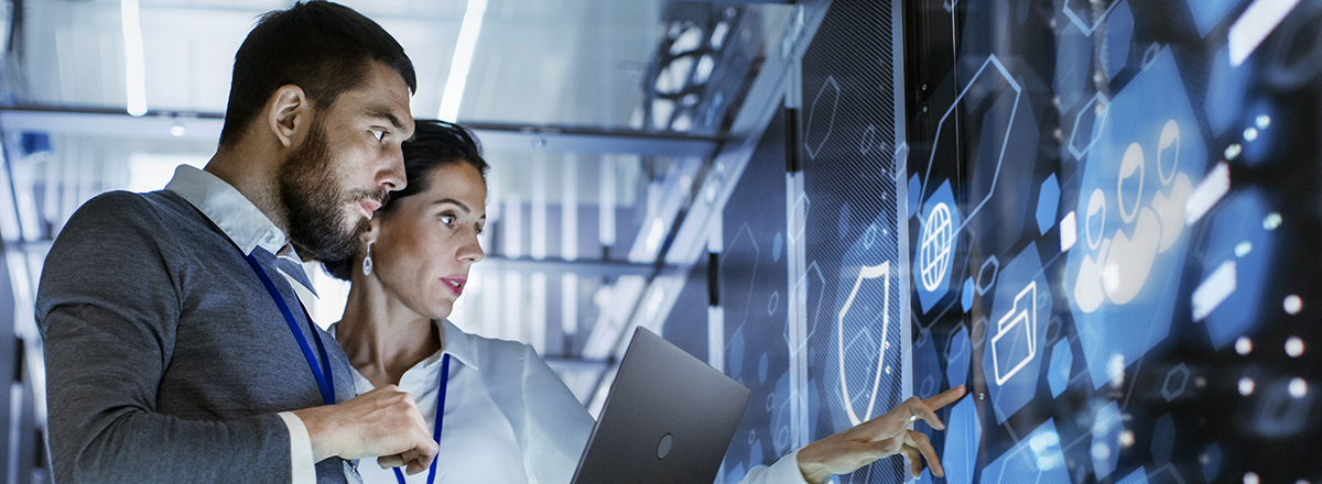 Security professionals looking at a wall of data