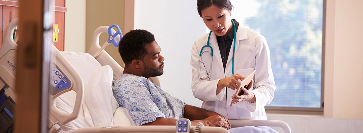 Doctor showing a patient his charts on a tablet