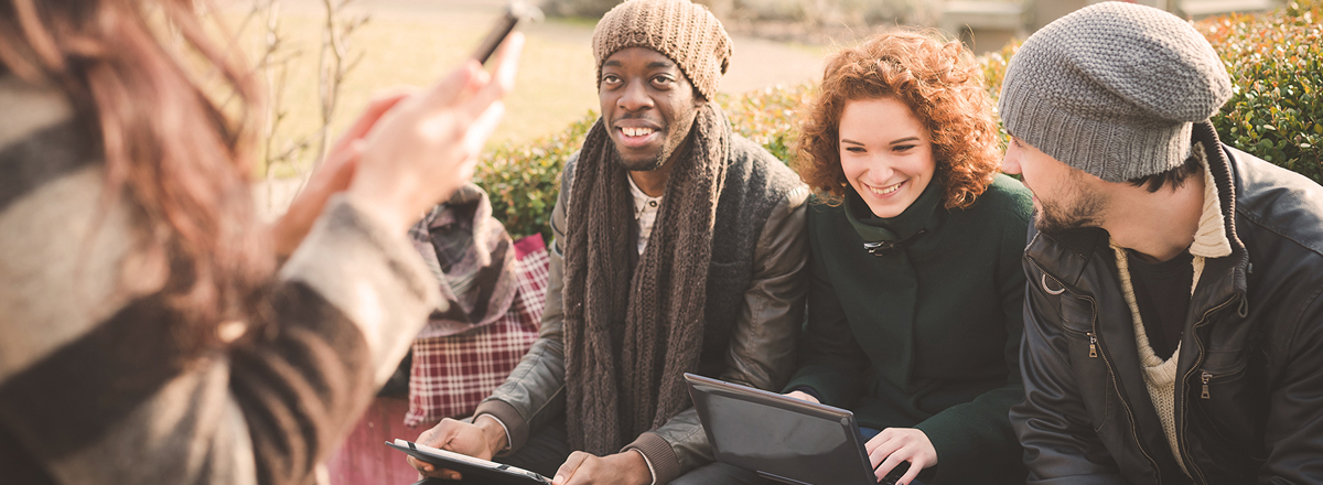 Students talking outdoors in winter clothes