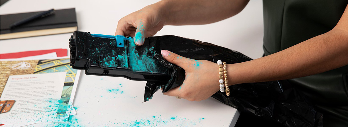 Woman holding blue toner cartridge