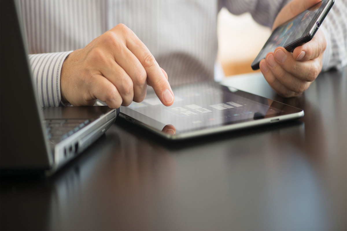 Businessman using a tablet and laptop