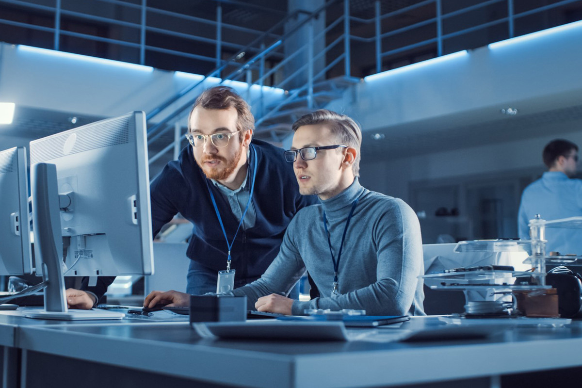 Two men looking at a computer screen