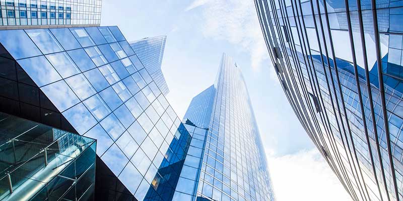 Photo of city buildings looking upward from street level