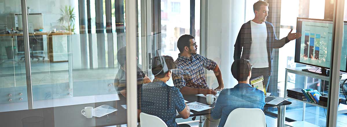 Co-workers looking at charts in a meeting room