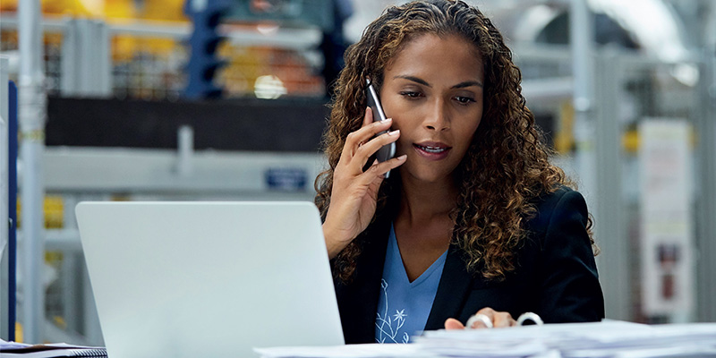 woman on phone with laptop