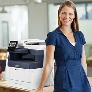 Smiling woman in front of Xerox VersaLink B405 MFP