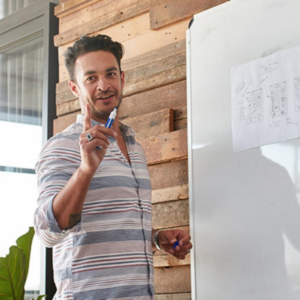 Man presenting at whiteboard