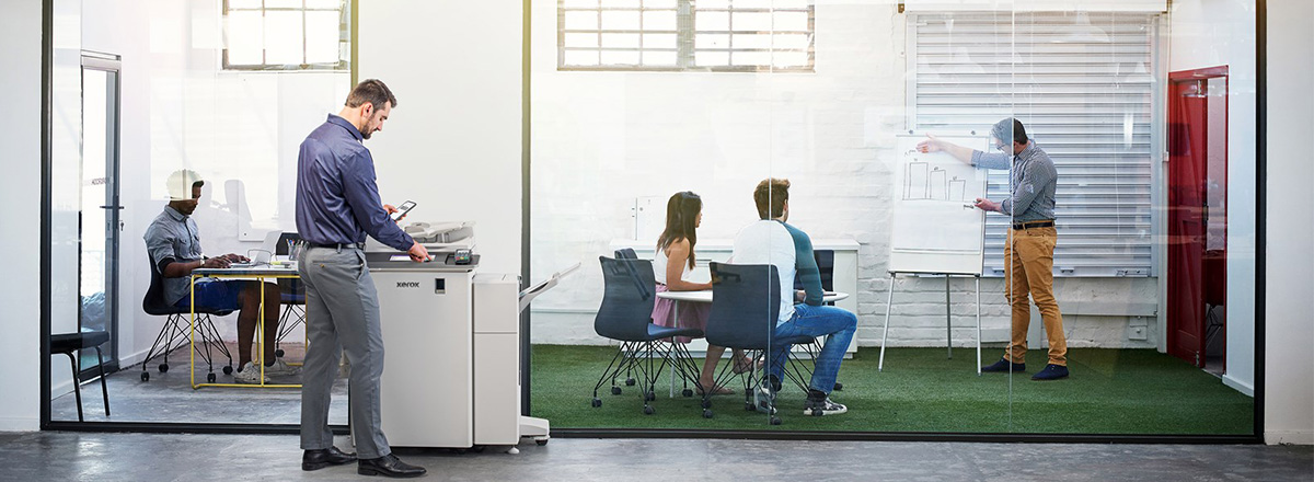 Man printing from a smartphone in a busy office