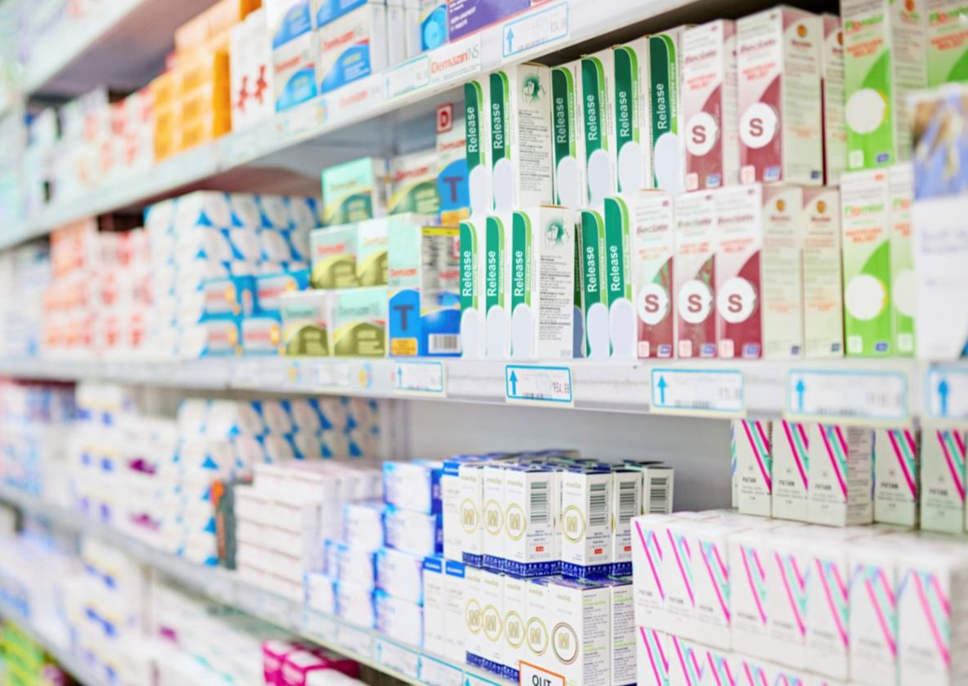 A store aisle with many cardboard boxes