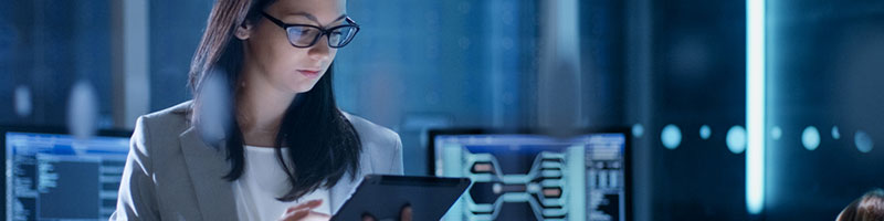 Woman working on a tablet in a secure server room