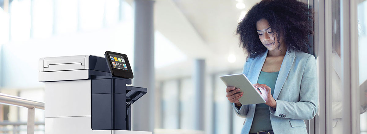 Woman printing from a tablet to a Xerox printer