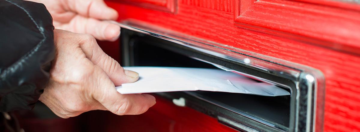 Letter being posted into mail box