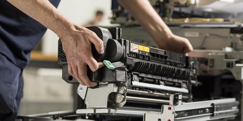 A person building a printer