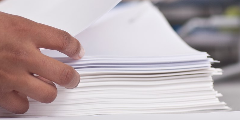 hand sorting stack of papers