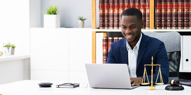 Man sitting at desk on laptop.