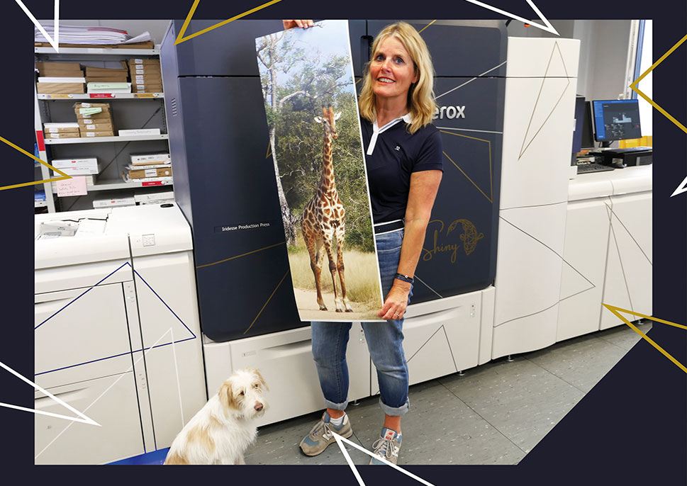 Birgit Hermes of Digital Druck Hilden shows print samples in front of their Xerox Iridesse Production Press