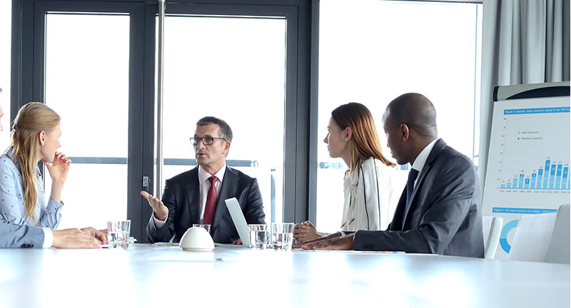 4 business people meeting in a conference room