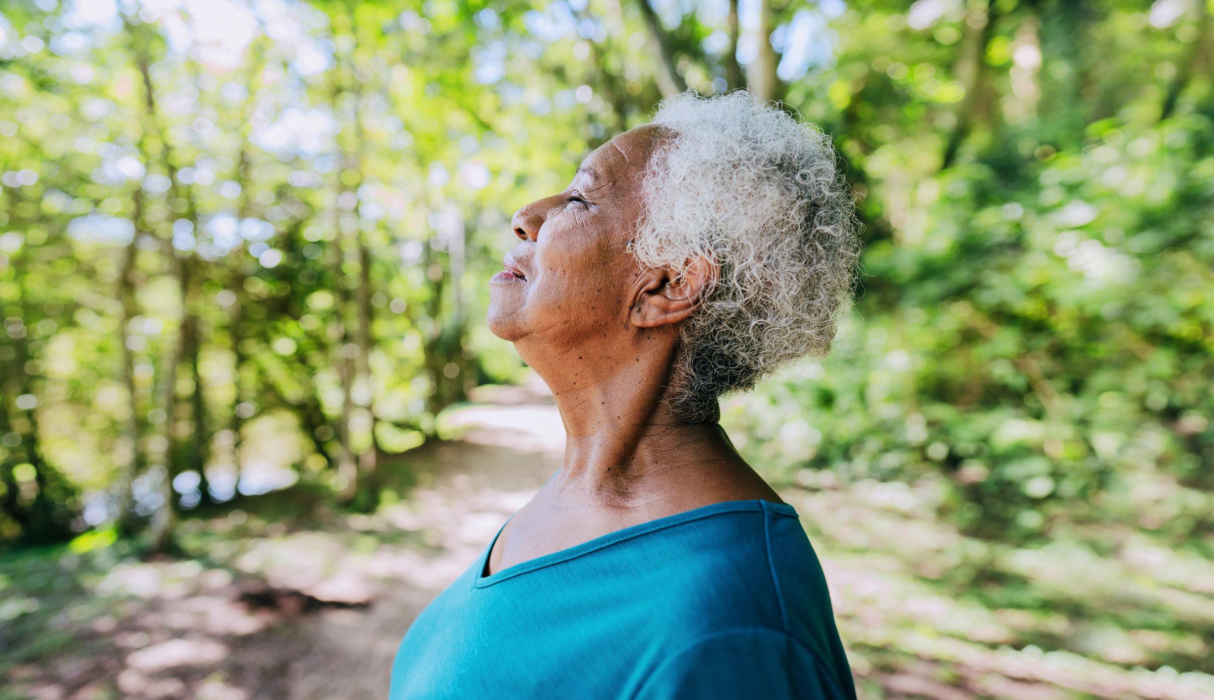 mature black woman deep breathing meditating stress