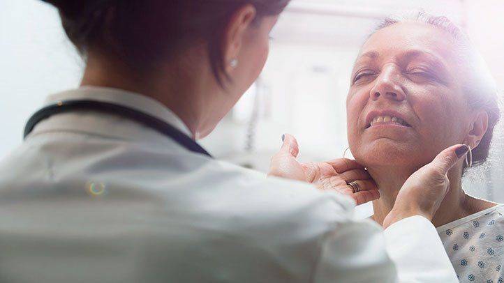 an endocrinologist checking a patient for hypothyroidism