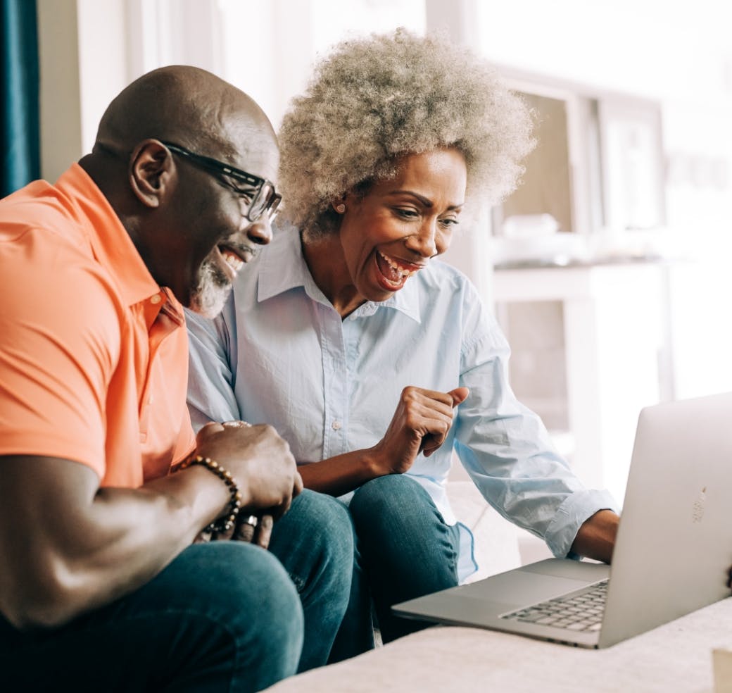 Man and woman looking at a laptop screen