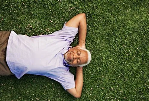 Photo of man laying on grass.